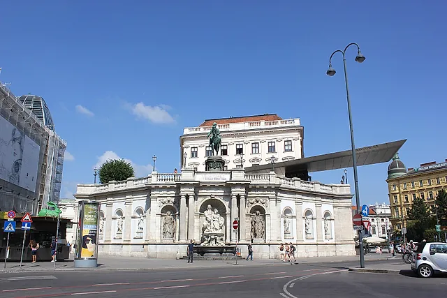 The Albertina on its bastion, with the Danubius fountain and the monument to Archduke Albert, under a blue sky