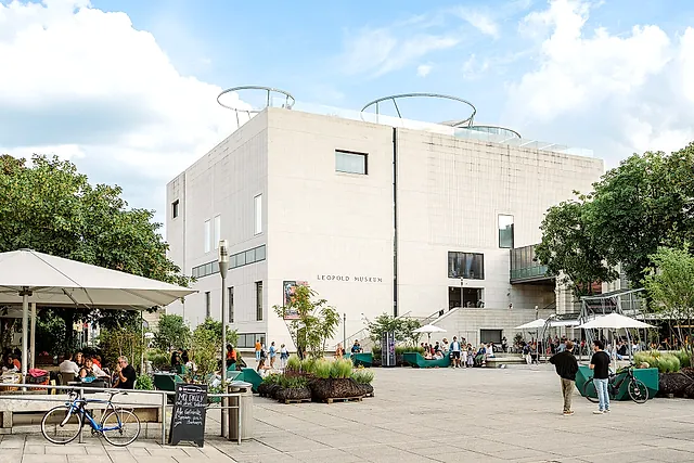 The white cube of the Leopold Museum above the main courtyard of the MuseumsQuartier, with its terrace and trees